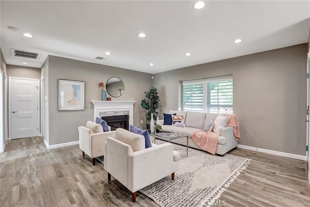 4437 Keever Ave, Long Beach, CA 90807 - living area featuring light wood finished floors, a fireplace, and recessed lighting