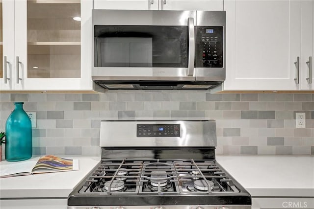 4437 Keever Ave, Long Beach, CA 90807 - kitchen featuring appliances with stainless steel finishes, white cabinets, light countertops, and backsplash