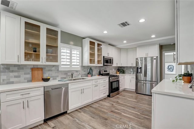 4437 Keever Ave, Long Beach, CA 90807 - kitchen featuring stainless steel appliances, white cabinets, light wood-style floors, light countertops, and recessed lighting