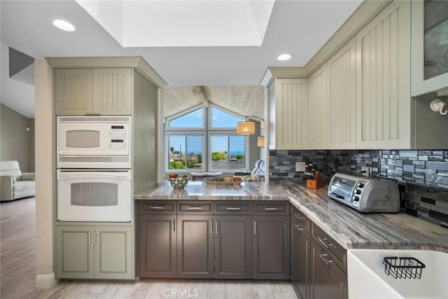 24532 Moonfire Dr, Dana Point, CA 92629 - kitchen featuring white appliances, light wood finished floors, tasteful backsplash, cream cabinetry, and light stone countertops