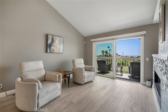 24532 Moonfire Dr, Dana Point, CA 92629 - sitting room with wood finished floors, a fireplace, and high vaulted ceiling