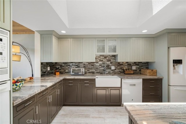 24532 Moonfire Dr, Dana Point, CA 92629 - kitchen with white appliances, recessed lighting, decorative backsplash, light stone counters, and glass insert cabinets