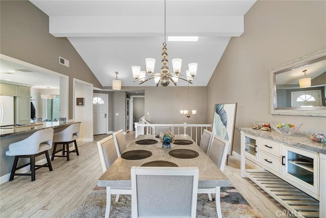 24532 Moonfire Dr, Dana Point, CA 92629 - dining room featuring a chandelier, beam ceiling, light wood-style floors, and high vaulted ceiling