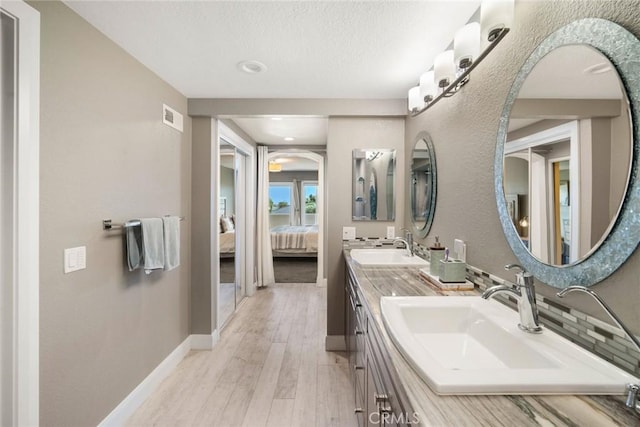 24532 Moonfire Dr, Dana Point, CA 92629 - full bathroom featuring ensuite bathroom, double vanity, and wood finished floors