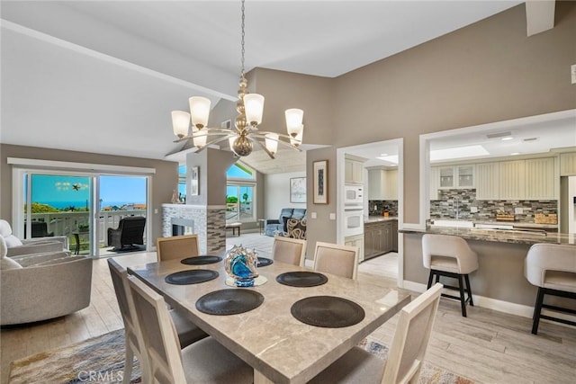 24532 Moonfire Dr, Dana Point, CA 92629 - dining area featuring a chandelier, light wood-style floors, high vaulted ceiling, and beam ceiling