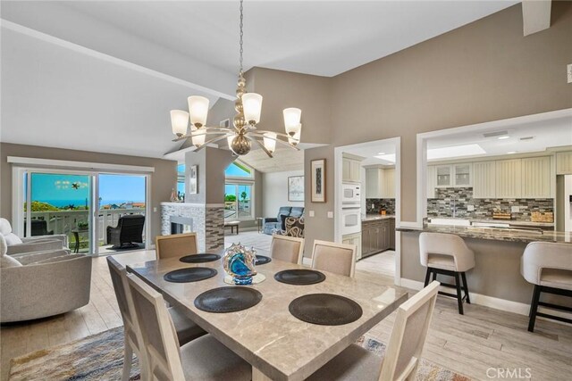 24532 Moonfire Dr, Dana Point, CA 92629 - dining area with a chandelier, light wood-style flooring, high vaulted ceiling, and beam ceiling
