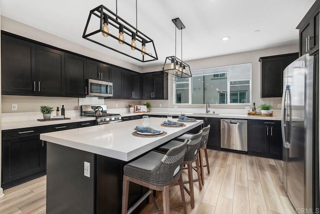 3510 Brody Way, Oceanside, CA 92056 - kitchen featuring appliances with stainless steel finishes, dark cabinetry, a center island, light countertops, and recessed lighting