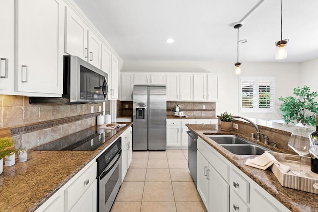1412 Long View Dr, Chula Vista, CA 91915 - kitchen with appliances with stainless steel finishes, backsplash, white cabinets, dark stone countertops, and recessed lighting
