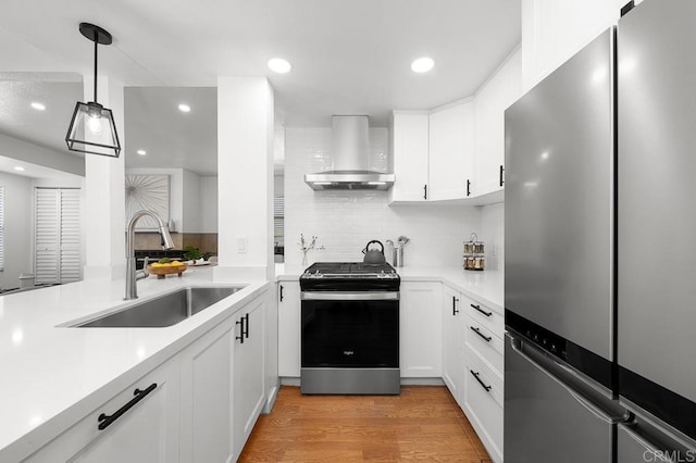 1802 Via Las Palmas Unit 36, National City, CA 91950 - kitchen featuring appliances with stainless steel finishes, wall chimney range hood, tasteful backsplash, light countertops, and recessed lighting