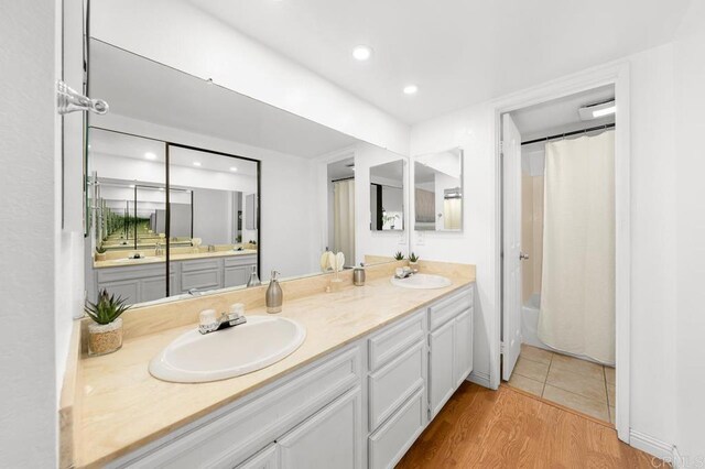 1802 Via Las Palmas Unit 36, National City, CA 91950 - bathroom with double vanity, wood finished floors, recessed lighting, and shower / bathtub combination with curtain