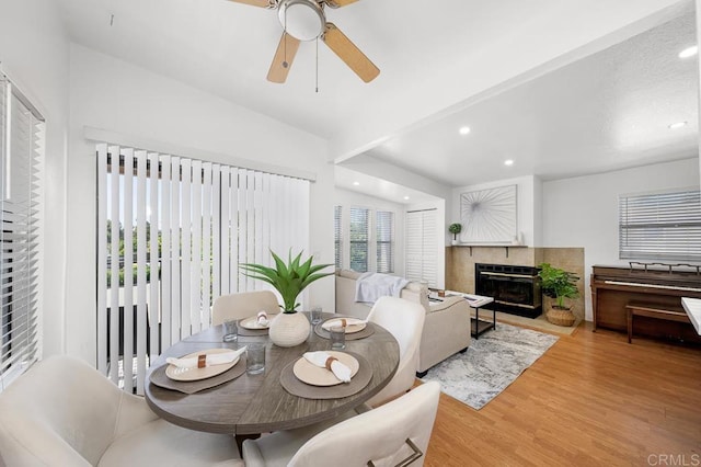 1802 Via Las Palmas Unit 36, National City, CA 91950 - dining area with wood finished floors, a glass covered fireplace, a ceiling fan, and recessed lighting