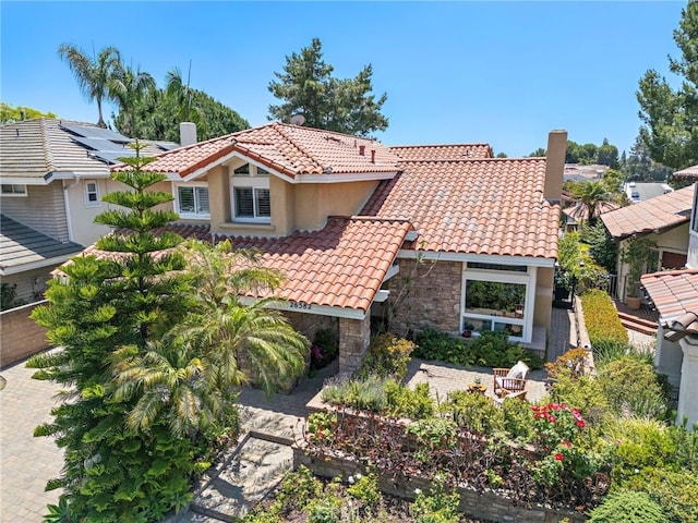 26582 Maside, Mission Viejo, CA 92692 - mediterranean / spanish home with a tiled roof, a chimney, stucco siding, and stone siding