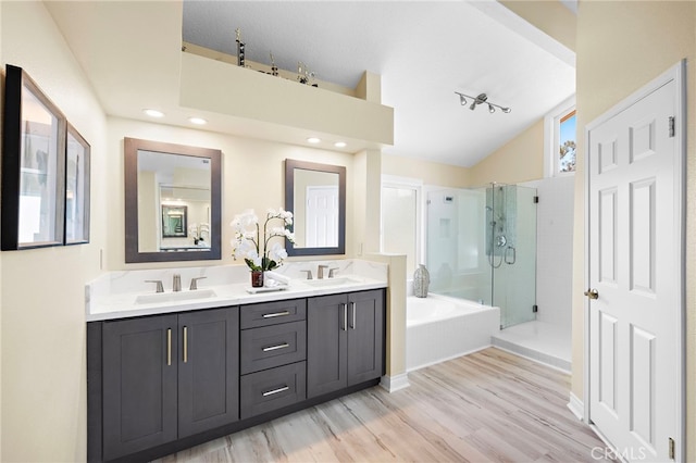 26582 Maside, Mission Viejo, CA 92692 - full bathroom featuring a shower stall, double vanity, wood finished floors, a garden tub, and vaulted ceiling