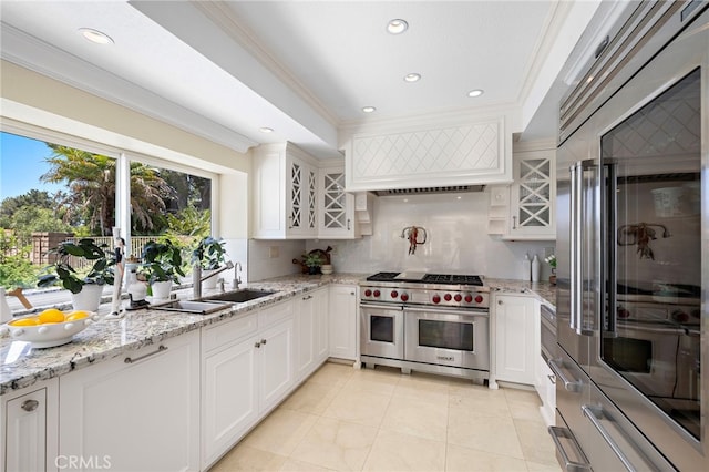 26582 Maside, Mission Viejo, CA 92692 - kitchen with high quality appliances, ornamental molding, light tile patterned floors, backsplash, and white cabinetry