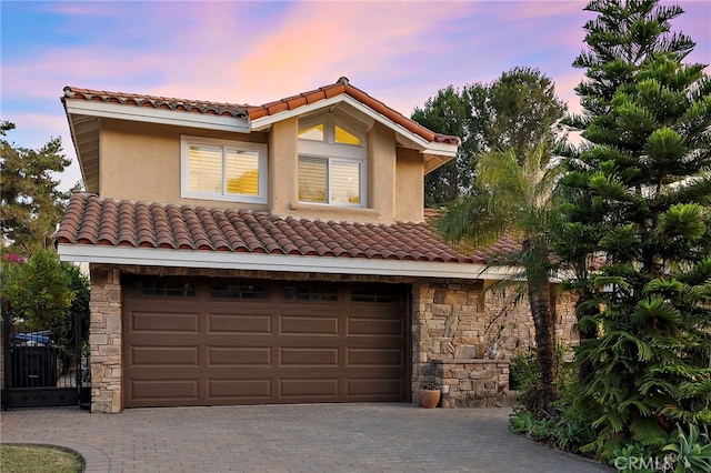 26582 Maside, Mission Viejo, CA 92692 - mediterranean / spanish house featuring a tile roof, stone siding, and a garage