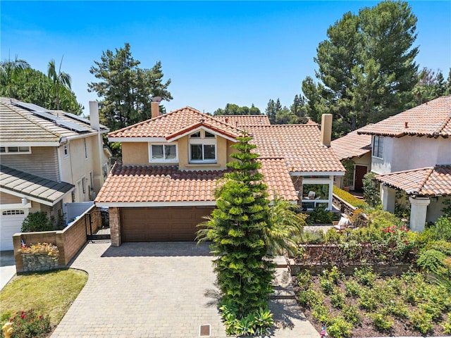 26582 Maside, Mission Viejo, CA 92692 - mediterranean / spanish home with a chimney, a tiled roof, a garage, stucco siding, and decorative driveway