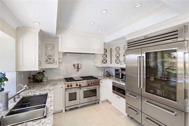 26582 Maside, Mission Viejo, CA 92692 - kitchen with built in appliances, backsplash, white cabinets, crown molding, and light stone counters