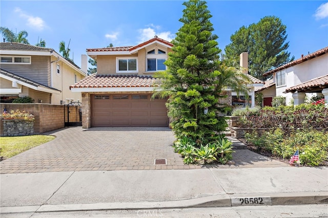26582 Maside, Mission Viejo, CA 92692 - mediterranean / spanish home with an attached garage, stucco siding, decorative driveway, a tile roof, and a gate