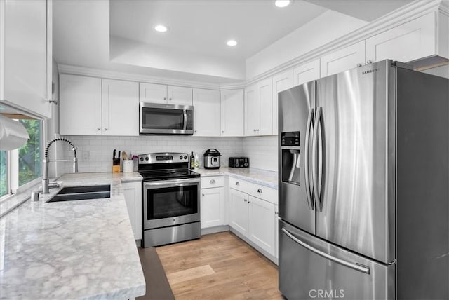 1380 Le Conte, Riverside, CA 92507 - kitchen with stainless steel appliances, white cabinetry, recessed lighting, tasteful backsplash, and light stone countertops