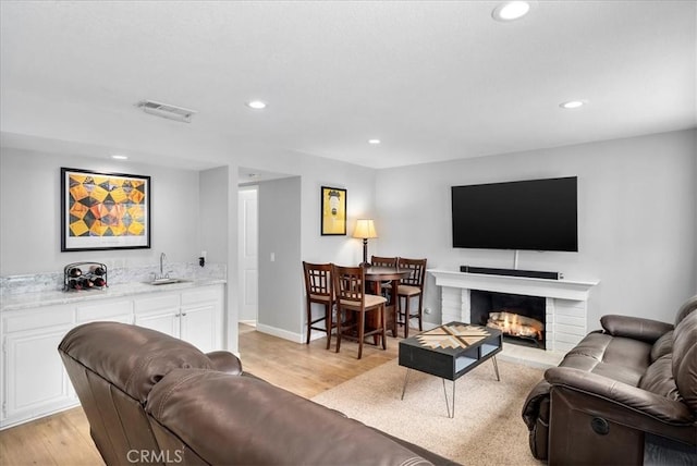 1380 Le Conte, Riverside, CA 92507 - living room with light wood finished floors, recessed lighting, a fireplace, and wet bar