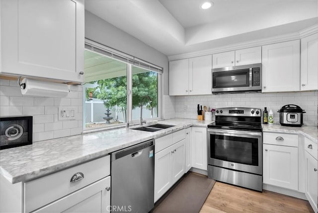 1380 Le Conte, Riverside, CA 92507 - kitchen with appliances with stainless steel finishes, white cabinetry, decorative backsplash, light stone countertops, and recessed lighting