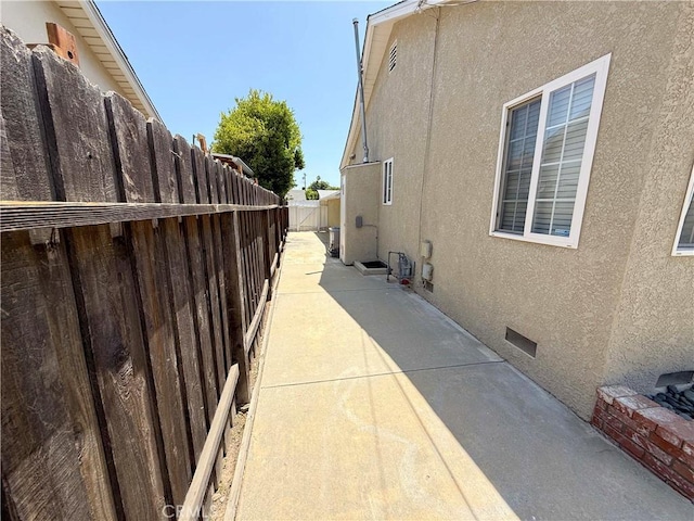21045 Hemmingway St, Canoga Park, CA 91304 - view of side of property with stucco siding, a patio, and crawl space