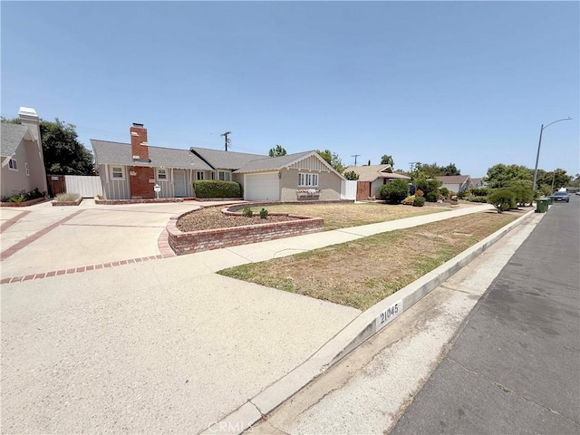 21045 Hemmingway St, Canoga Park, CA 91304 - ranch-style home featuring driveway, a garage, and a chimney