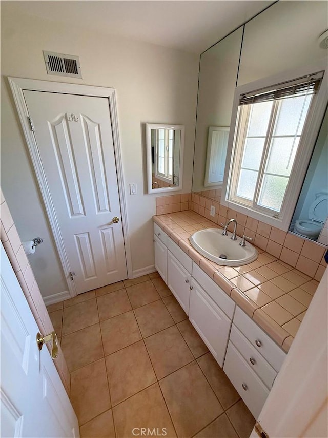 21045 Hemmingway St, Canoga Park, CA 91304 - bathroom featuring vanity, tile patterned flooring, and decorative backsplash
