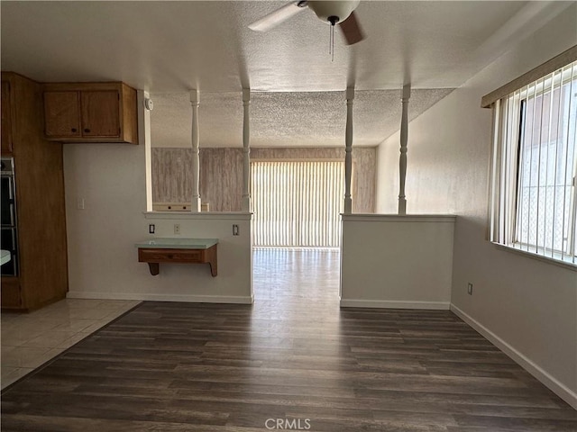 1624 Forane St, Barstow, CA 92311 - empty room featuring dark wood-type flooring, a textured ceiling, and a ceiling fan