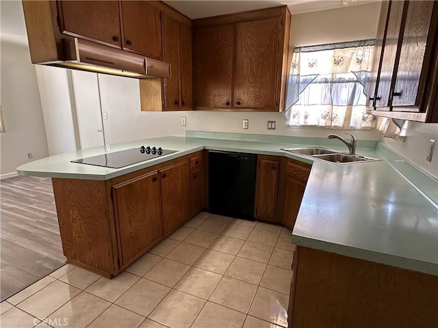 1624 Forane St, Barstow, CA 92311 - kitchen featuring black appliances, a peninsula, light countertops, and under cabinet range hood