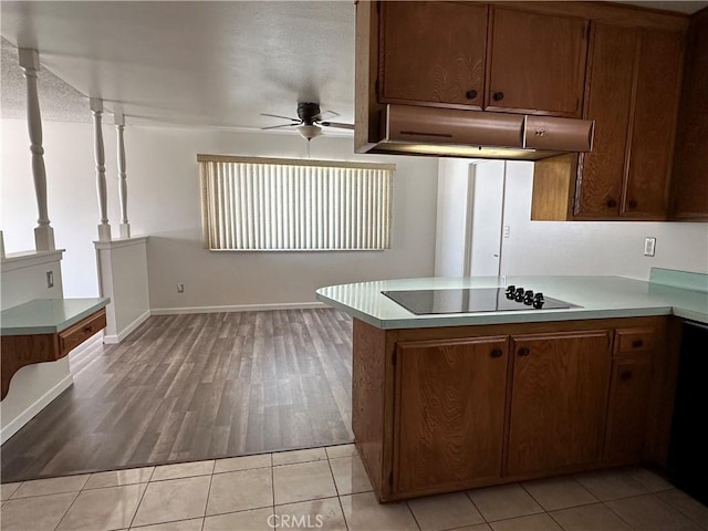 1624 Forane St, Barstow, CA 92311 - kitchen with black electric stovetop, a ceiling fan, under cabinet range hood, and light countertops