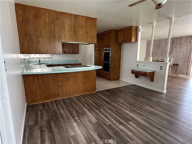1624 Forane St, Barstow, CA 92311 - kitchen with wood finished floors, brown cabinets, and a peninsula