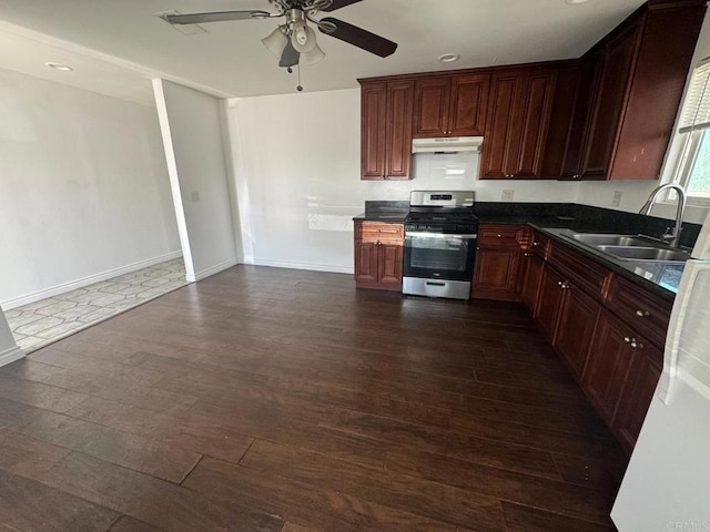 734738 Grand Ave, Spring Valley, CA 91977 - kitchen featuring stainless steel range with gas stovetop, under cabinet range hood, dark wood finished floors, dark countertops, and ceiling fan