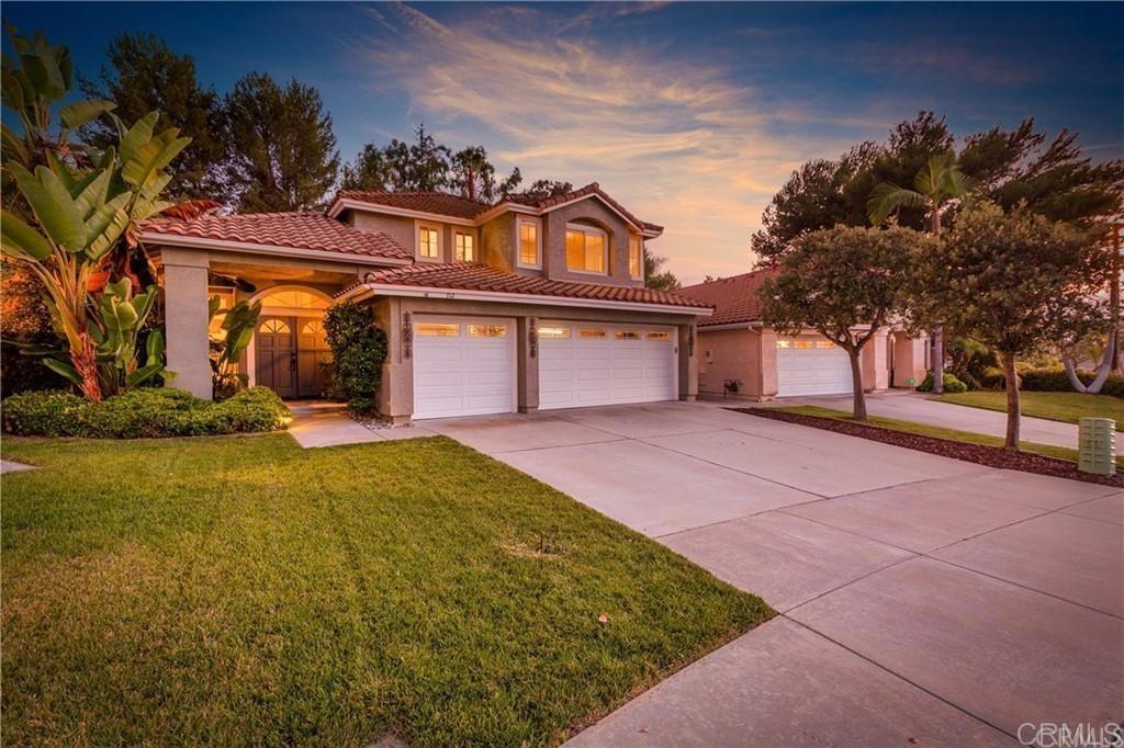 712 Palette Ct, Oceanside, CA 92057 - view of front of home featuring driveway, a tile roof, a lawn, stucco siding, and an attached garage