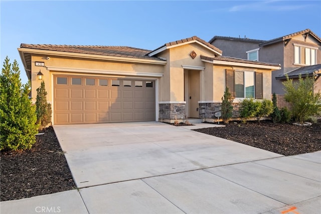 431 Daniella Way, Perris, CA 92570 - mediterranean / spanish house featuring driveway, an attached garage, stucco siding, and stone siding