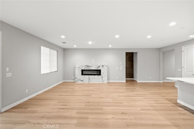 431 Daniella Way, Perris, CA 92570 - unfurnished living room with recessed lighting, a fireplace, and light wood-style flooring