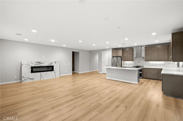 431 Daniella Way, Perris, CA 92570 - kitchen with stainless steel appliances, wall chimney exhaust hood, open floor plan, recessed lighting, and light countertops