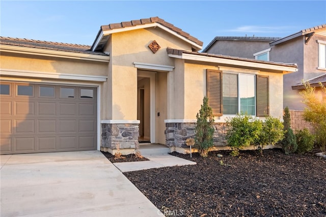 431 Daniella Way, Perris, CA 92570 - view of front facade featuring stone siding, an attached garage, driveway, and stucco siding