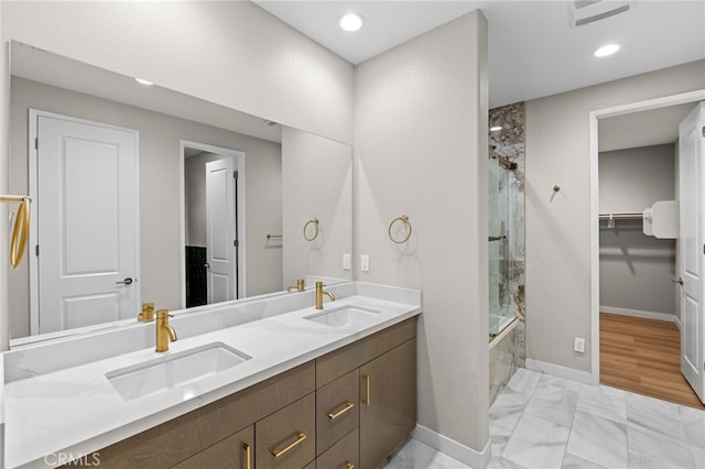431 Daniella Way, Perris, CA 92570 - bathroom with double vanity, marble look tile flooring, a walk in closet, and recessed lighting