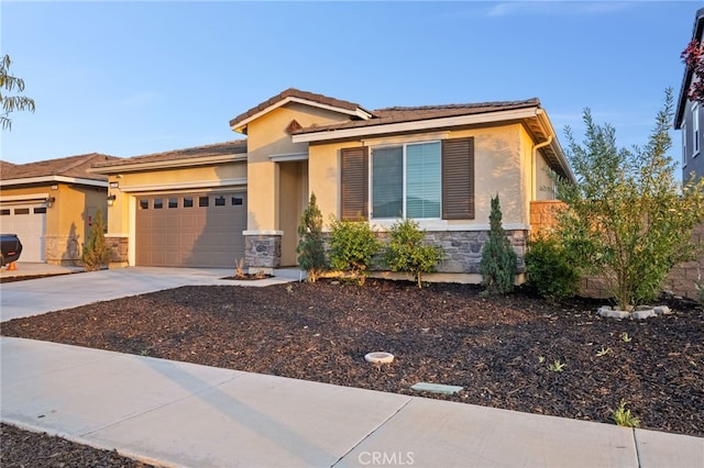 431 Daniella Way, Perris, CA 92570 - view of front of house featuring stone siding, stucco siding, an attached garage, and driveway