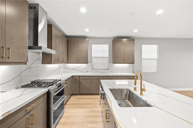 431 Daniella Way, Perris, CA 92570 - kitchen featuring wall chimney range hood, range with two ovens, light wood-type flooring, light stone countertops, and recessed lighting