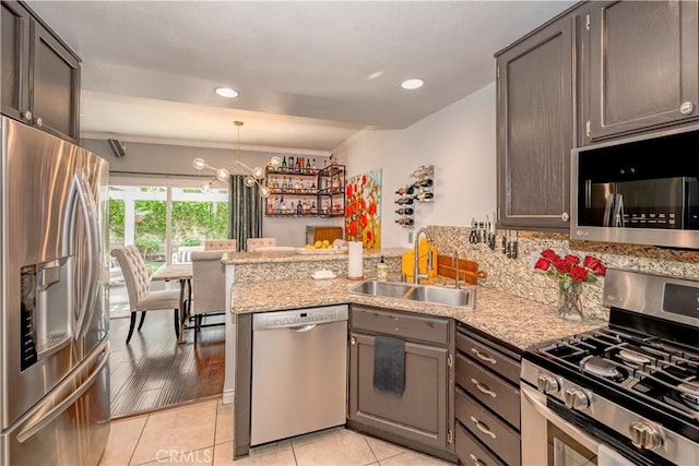 22943 Banyan Pl Unit 306, Saugus, CA 91390 - kitchen with stainless steel appliances, a peninsula, crown molding, light tile patterned floors, and pendant lighting
