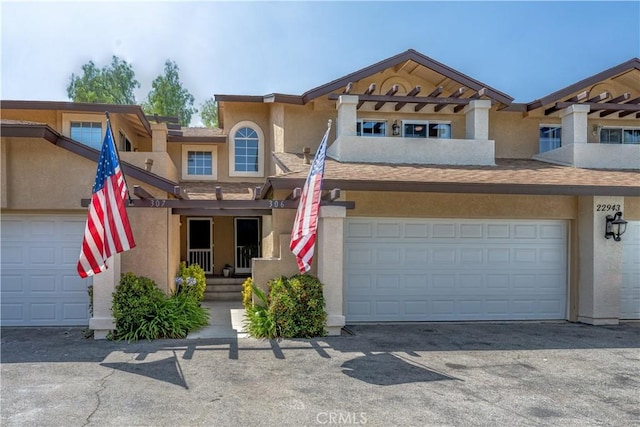 22943 Banyan Pl Unit 306, Saugus, CA 91390 - view of property with stucco siding and asphalt driveway