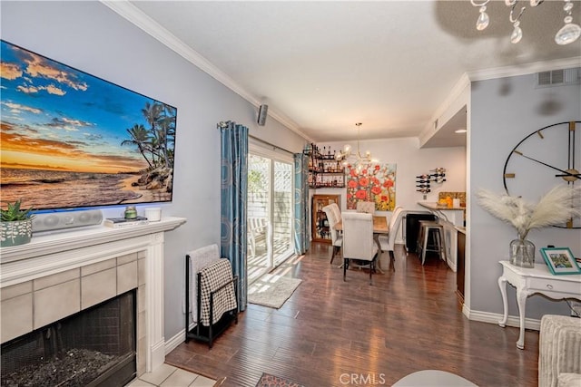 22943 Banyan Pl Unit 306, Saugus, CA 91390 - living area with a chandelier, ornamental molding, wood finished floors, and a tile fireplace