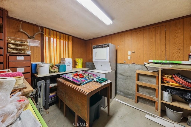 26314 Jacqueline Rd, Twin Peaks, CA 92391 - misc room featuring stacked washer / dryer, unfinished concrete flooring, and wooden walls