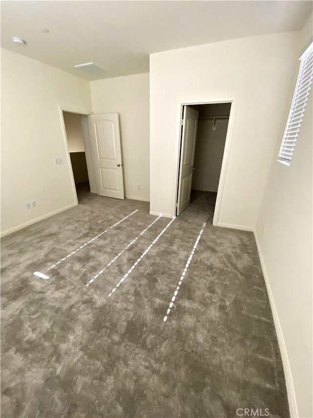16620 Wyndham Ln Unit 11, Fontana, CA 92336 - unfurnished bedroom with carpet flooring and a walk in closet