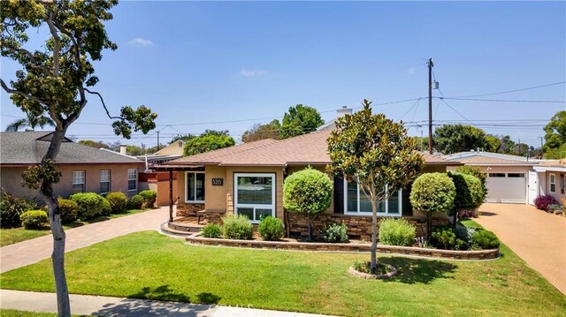 5215 E Monlaco Rd, Long Beach, CA 90808 - view of front of property featuring driveway, a front lawn, a garage, and stone siding