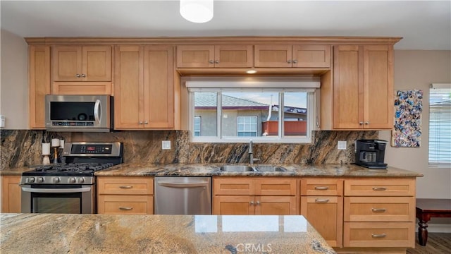 5215 E Monlaco Rd, Long Beach, CA 90808 - kitchen with stainless steel appliances, light stone counters, healthy amount of natural light, and backsplash