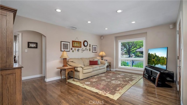 5215 E Monlaco Rd, Long Beach, CA 90808 - living room with arched walkways, wood finished floors, and recessed lighting