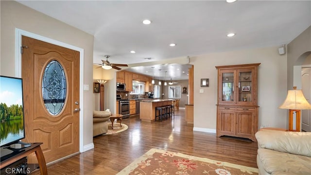 5215 E Monlaco Rd, Long Beach, CA 90808 - foyer entrance featuring wood finished floors, ceiling fan, arched walkways, and recessed lighting